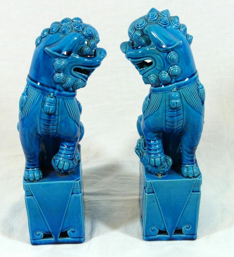 PAIR OF 20TH CHNESE BLUE GLAZED PORCELAIN FOO DOGS: Fabulous pair of 20th century Chinese porcelain royal blue glazed foo dogs on attached bases. Measures 14" (36 cm) height.