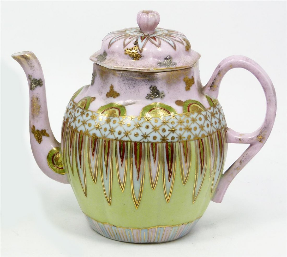 A A VANTINE JAPANESE PORCELAIN HAND PAINTED TEAPOT: Old Ashley Abraham Van Tine Japanese porcelain teapot. Has a gold hand painted design over pink ground. Bottom holds stamp form crossed flags mark. Late 19th to early 20th century. Measures 6 3/8" hei