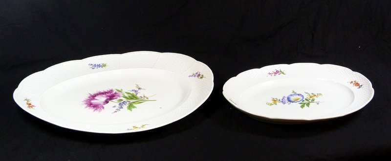 2 MEISSEN BASKET WEAVE OVAL SERVING PLATTERS: A lot of two Meissen German porcelain hand painted floral oval platters having embossed basket weave design to rims. Each holds blue under glaze crossed swords marks. 19th/20th century. Platters measu
