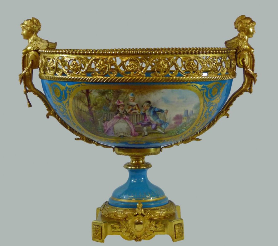 LARGE 18th C SEVRES ORMOLU MOUNTED CENTERPIECE: A large and impressive antique 18th century Sevres French porcelain ormolu gilt bronze mounted centerpiece having figural winged female busts to ends propped up on floral scrolled reticulated bronze r