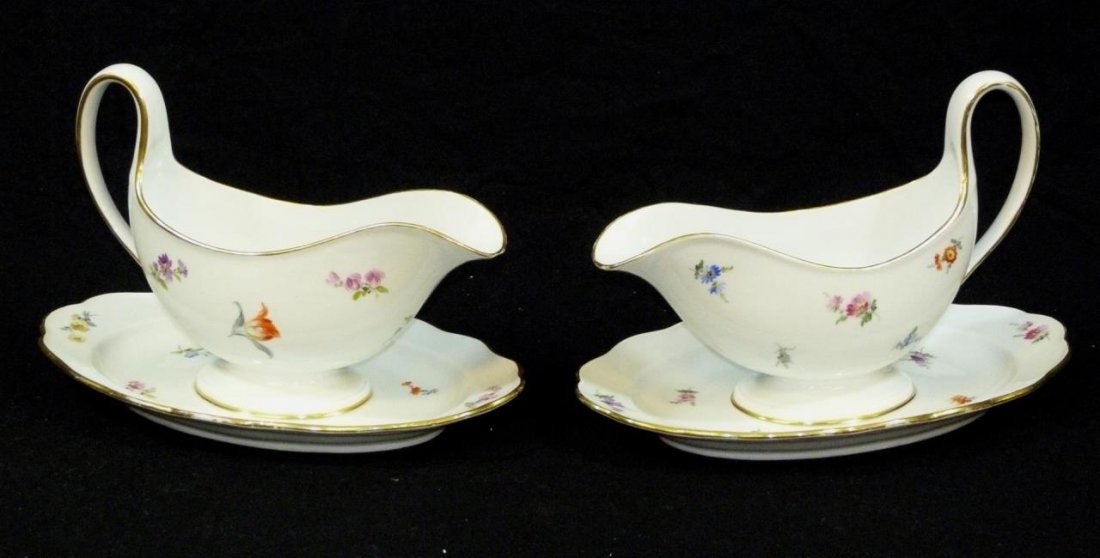 2 MEISSEN 19th C GERMAN PORCELAIN GRAVY BOATS: A pair of antique Meissen German porcelain gravy boats having attached under plates. Each in the scattered flower pattern. Bottoms hold blue under glaze crossed swords marks. Each measures approx. 6 5
