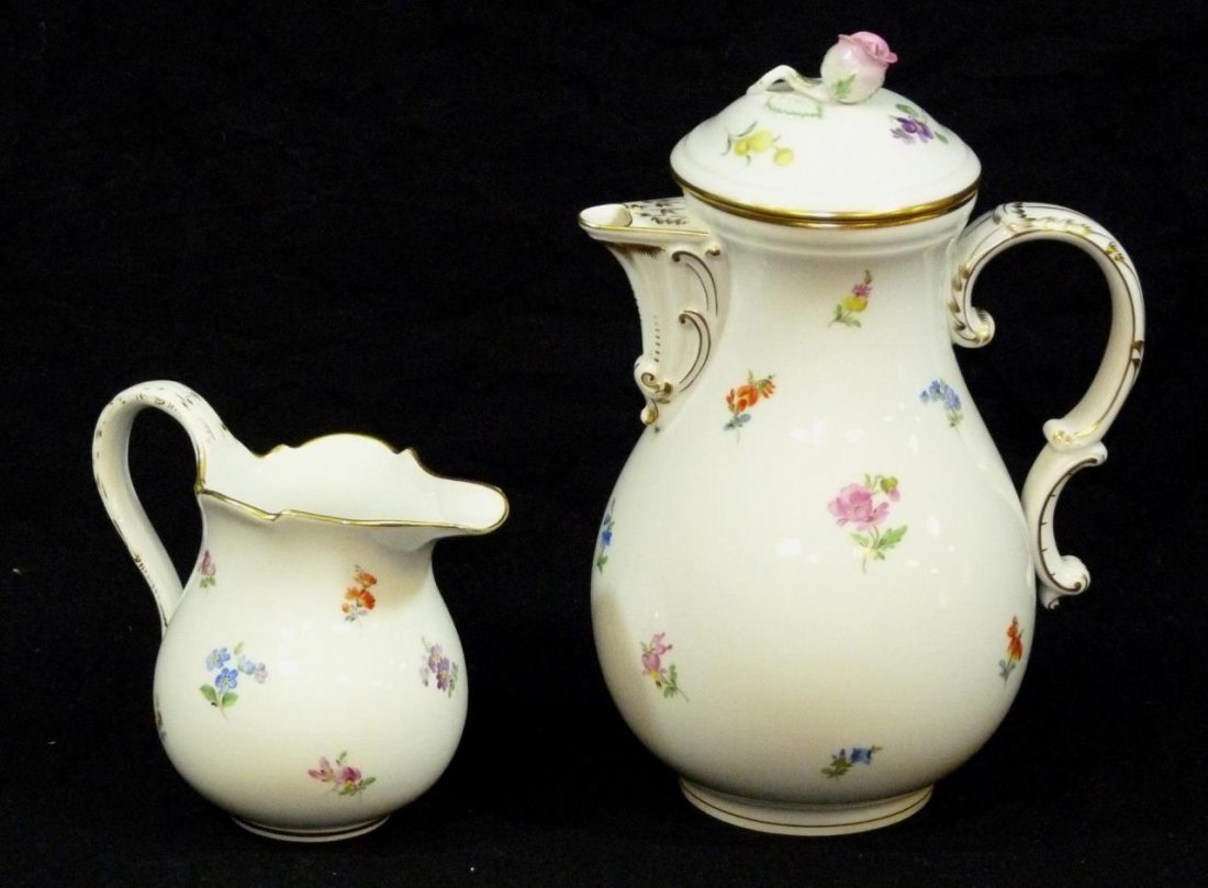 MEISSEN PORCELAIN COFFEE POT AND CREAMER SET: Antique Meissen hand painted German porcelain 'Scattered Flowers' coffee pot and creamer. Each holding blue crossed swords marks to bottom. Tallest piece 10 3/8" height (26.3cm). Total weight of 1372