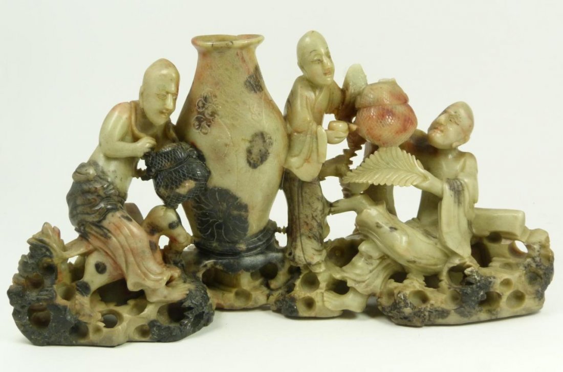 CHINESE HAND CARVED SOAPSTONE IMMORTALS GROUP: A Chinese carved soapstone sculpture depicting immortals with vase to center. 19th/20th century. Measures 6 1/4" height x 12 1/2" width (15.8cm x 31.7cm).
