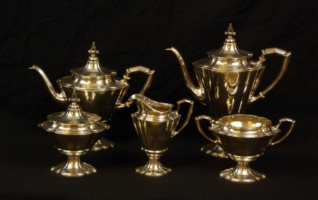 5 PIECE WALLACE STERLING SILVER TEA SET, 1919: Five piece Wallace sterling silver tea set having a rounded ribbed design. Set consists of: coffee pot (10 7/8"), teapot (8 7/8"), covered sugar (6 7/8"), creamer (5 7/8") and wastebasket (5 1/4"). Ea