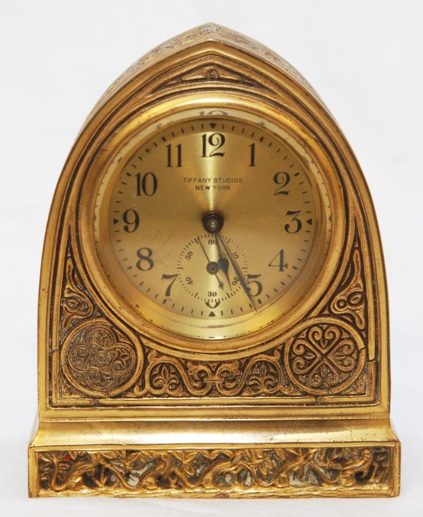 TIFFANY STUDIOS VENETIAN GILT BRONZE DESK CLOCK: Tiffany Studios gilded bronze 'Venetian' pattern desk clock. Numbered 1851. Early 20th century. Includes original key. Measures 5 5/8" height x 4 1/2" width (14.2cm x 11.4cm). Total weight of 1709 gra