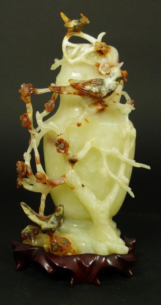 CHINESE TRANSLUCENT JADE LIDDED VASE WITH BIRDS: Chinese finely carved jade vase lidded vase with birds and branches with flowers. Beautiful translucent yellowish white color with some russet suffusions. Includes fitted wooden base. 19th/20th centur