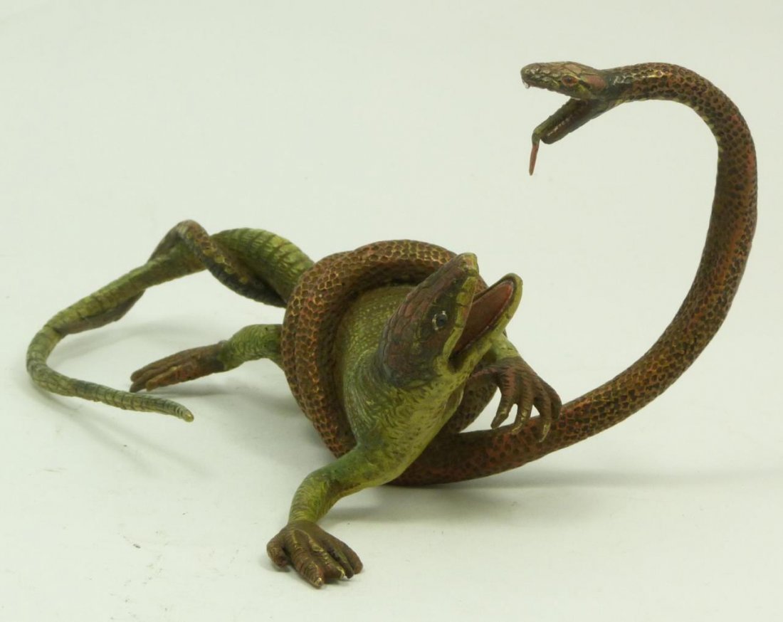 VIENNA STYLE COLD PAINTED BRONZE SNAKE VS LIZARD: Vienna style cold painted bronze sculpture depicting a serpent fighting a lizard. Marked Geschutz to bottom and numbered 5301. Measures 4 1/4" height x 7 1/2" length (10.7cm x 19.1cm). Total weight of