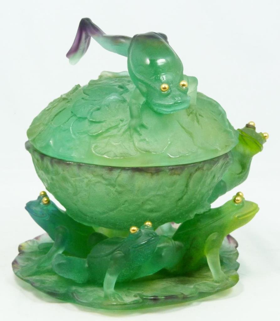 DAUM PATE DE VERRE COVERED FROG COMPOTE: Daum Pate de Verre art glass covered compote having a figural frogs on lily pad design. Green to purple and yellow art glass tones. Script Daum France mark to bottom of base. Measures 8 1/4" height x 