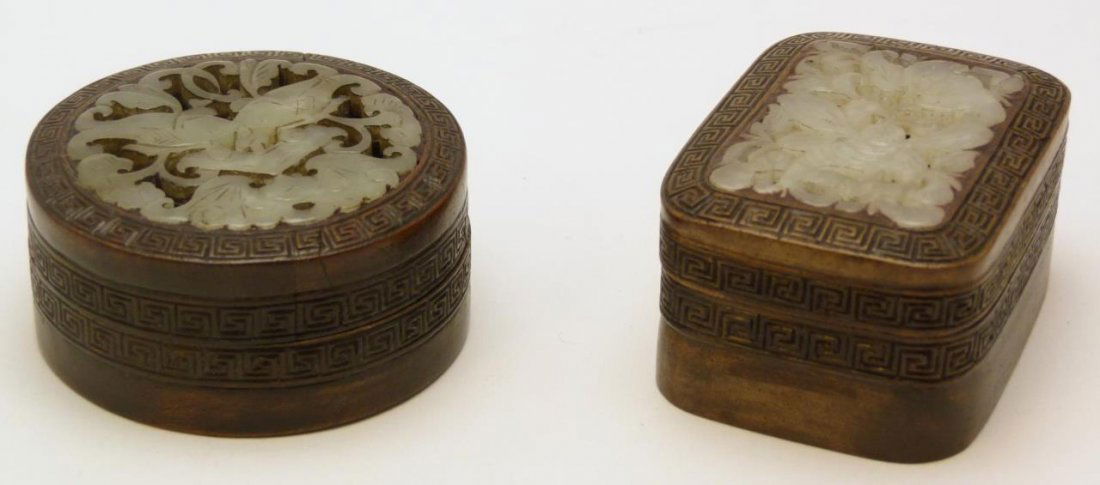 Pr CHINESE ROSEWOOD JADE INLAID CARVED BOXES: A pair of Chinese hand carved rosewood boxes having reticulated inlaid jade plaques to covers. One round with dual fish and bat design, the other rectangular depicting butterfly and bat. Largest measu