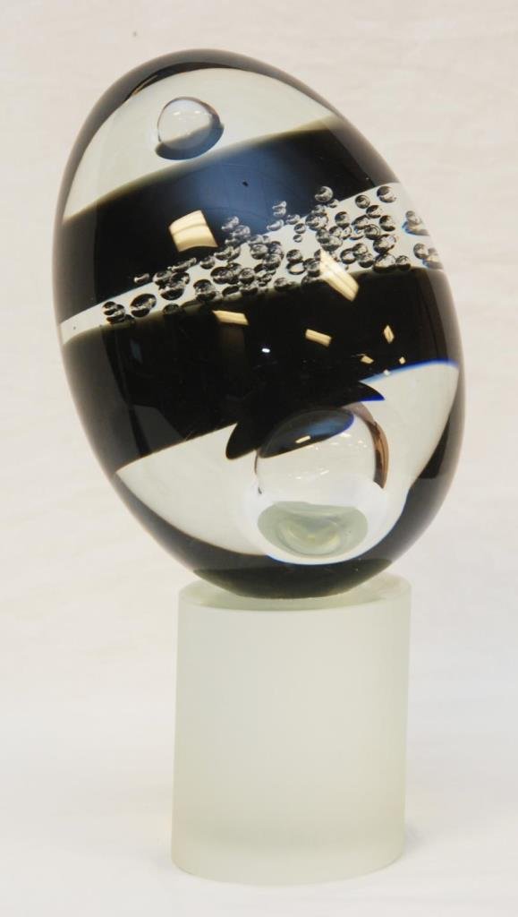 ARTIST SIGNED MURANO STYLE ART GLASS EGG SCULPTURE: Hand signed 20th century Murano style art glass egg form sculpture. Black and purple to clear colors with interior air bubble design. Mounted on frosted cylindrical glass base. Hand signed to bottom o