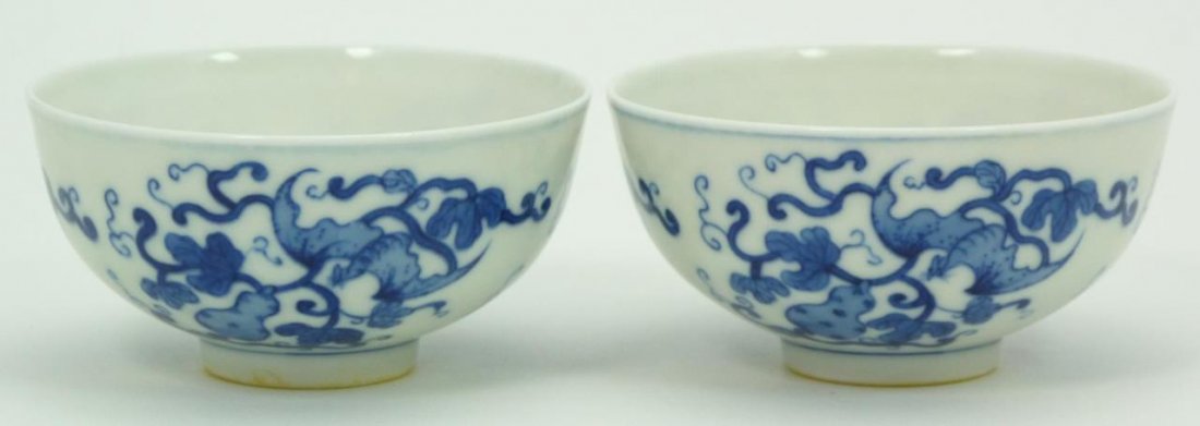 Pr 18th C CHINESE BLUE & WHITE PORCELAIN BOWLS: A pair of antique Chinese Qing dynasty period blue and white porcelain bowls depicting bats amongst vines and hulu double gourds. Bottoms hold blue four character calligraphy marks. Circa Qing Dynasty