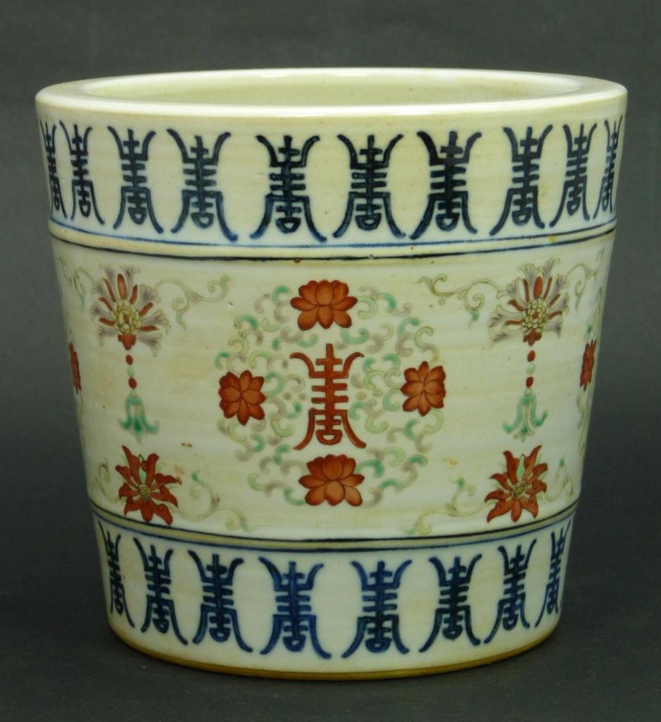 19th C CHINESE PORCELAIN LONGEVITY BRUSH POT: Antique Chinese hand painted enameled brush pot depicting iron red and blue longevity symbols throughout. Iron red lotus blossoms and screen scrolls also decorate the exterior. Bottom holds blue six c
