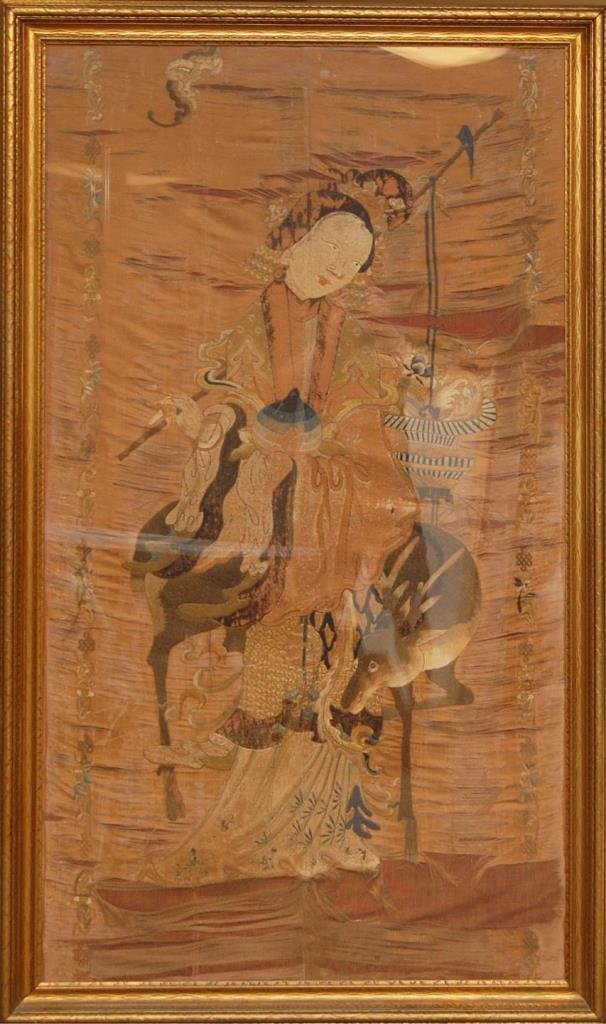 QING DYNASTY LARGE CHINESE SILK MAIDEN EMBROIDERY: A large Chinese silk embroidery depicting a maiden with deer and bats. Circa Qing Dynasty period, Mounted gilded wooden frame behind glass screen. Measures 66" height x 36" width + 3" frame (167.6cm x