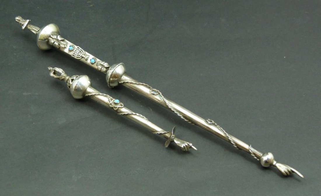 2 JUDAIC RUSSIAN SILVER YAD TORAH POINTERS: A lot of two Russian silver Judaic Yad Torah pointers. Each with rapping wire and jeweled with turquoise. One having applique menorah and flowers. Hasid reading book and crown figural finials decorate