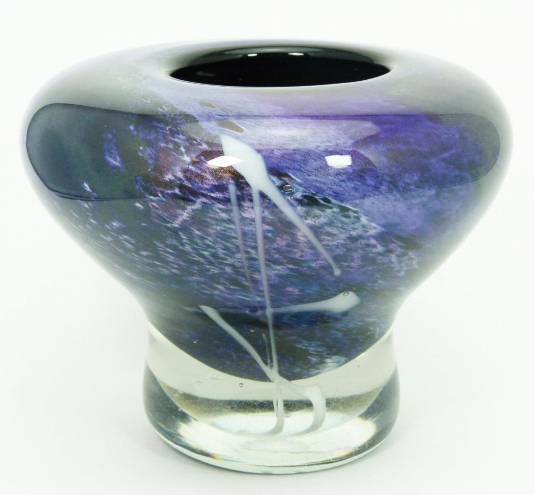 STEPHEN FELLERMAN STUDIO GLASS IRIDESCENT VASE '87: A 1987 Stephen Fellerman studio glass vase having a iridescent purple and green to clear color. One side having a white suffusion design. Signed Fellerman 87 to bottom. Also marked 9/09. Measures 5 7/