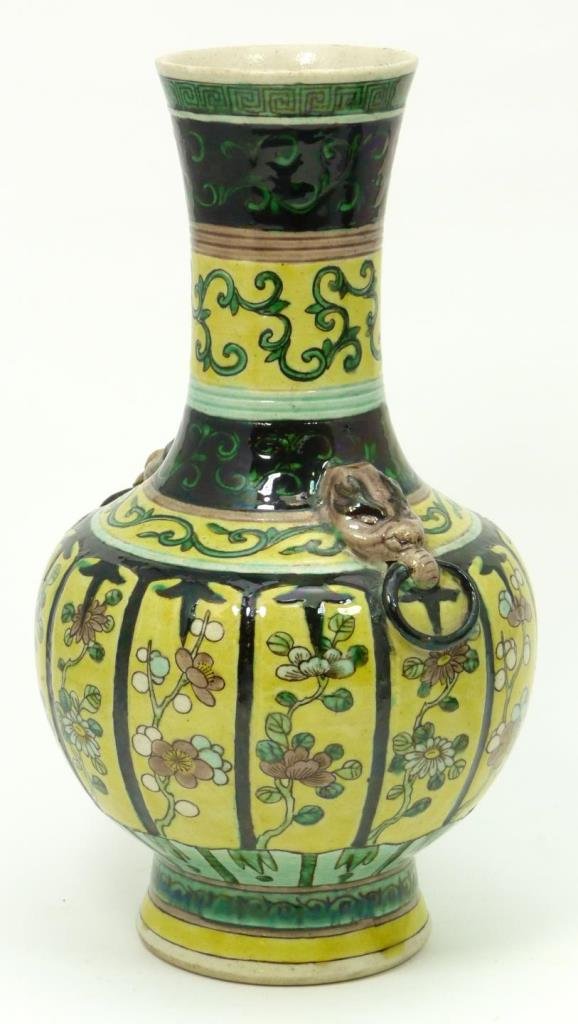 CHINESE EARTHENWARE FLORAL BALUSTER VASE: Chinese earthenware floral bottle form vase having figural elephant head handles with rings. Floral designs throughout over yellow and black grounds. Measures 8 7/8" height (22.5cm). Total weight of 7