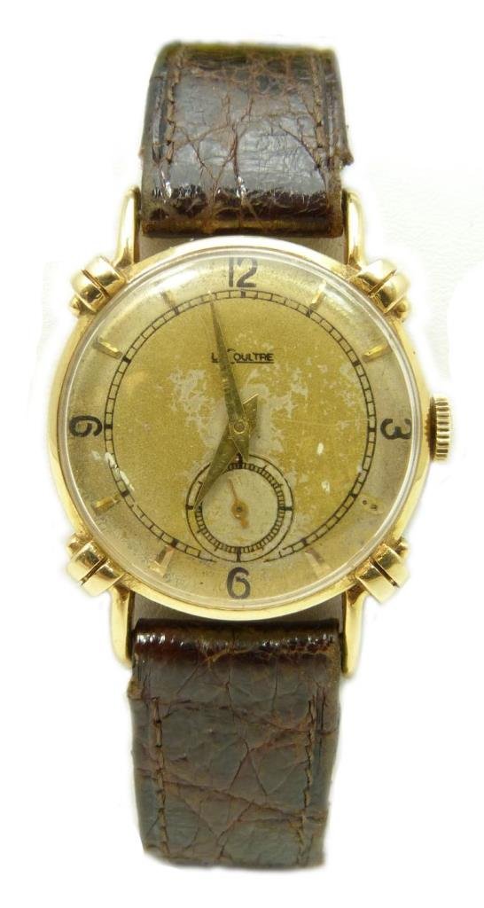 JAEGER LECOULTRE 14K YELLOW GOLD FANCY LUGS WATCH: Gent's Jaeger LeCoultre 14k yellow gold wristwatch. Has a gold and silver tone face with black numerals. Gold tone hour, minute and sub-second hands. Fancy Lugs design to case. Domed glass screen. Cir