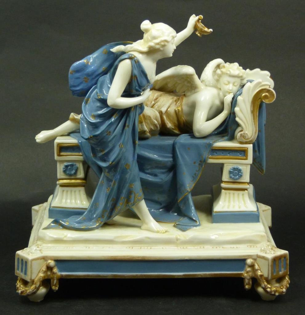 ANTIQUE GINORI PSYCHE & CUPID GROUP SCULPTURE: Antique Marchese Ginori Capodimonte Italian porcelain two figure group sculpture depicting Psyche pouring wine from an oil lamp over Cupid as he sleeps on a recamier. Blue seven point crown over N Nap