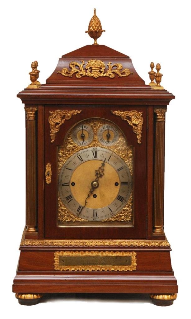 ENGLISH MAHOGANY BREAK ARCH 8 CHIME BRACKET CLOCK: Antique English mahogany case break arch eight chime bracket clock. Has gold and silver tone face with black Roman numerals. Scrolled hour and minute hands. Locking hinged face and movement access doo
