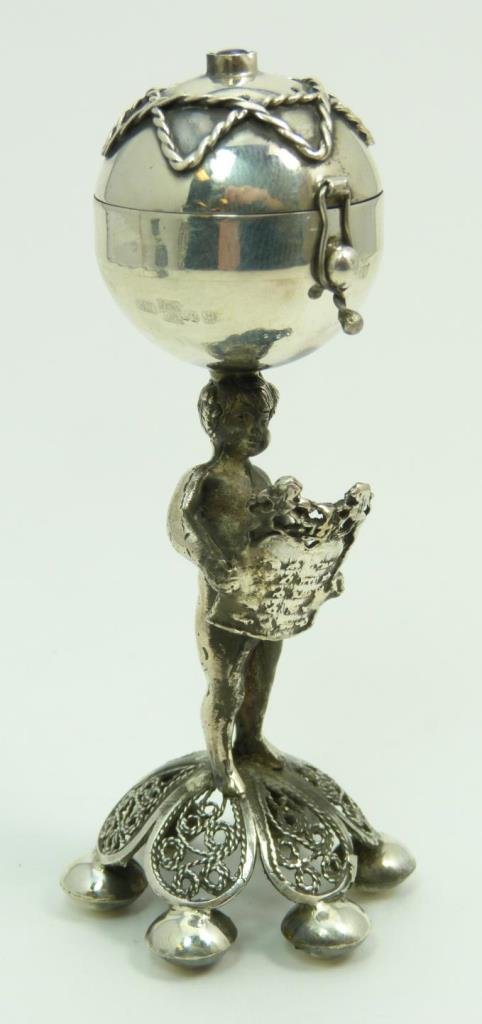 RUSSIAN SILVER JUDAIC FIGURAL SCENT BOX: A Russian silver Judaic figural scent box depicting a standing cherub holding plaque with Ten Commandments. Holds impressed 84 silver purity, town, assayer and workmaster marks. Measures approx. 4 3/8