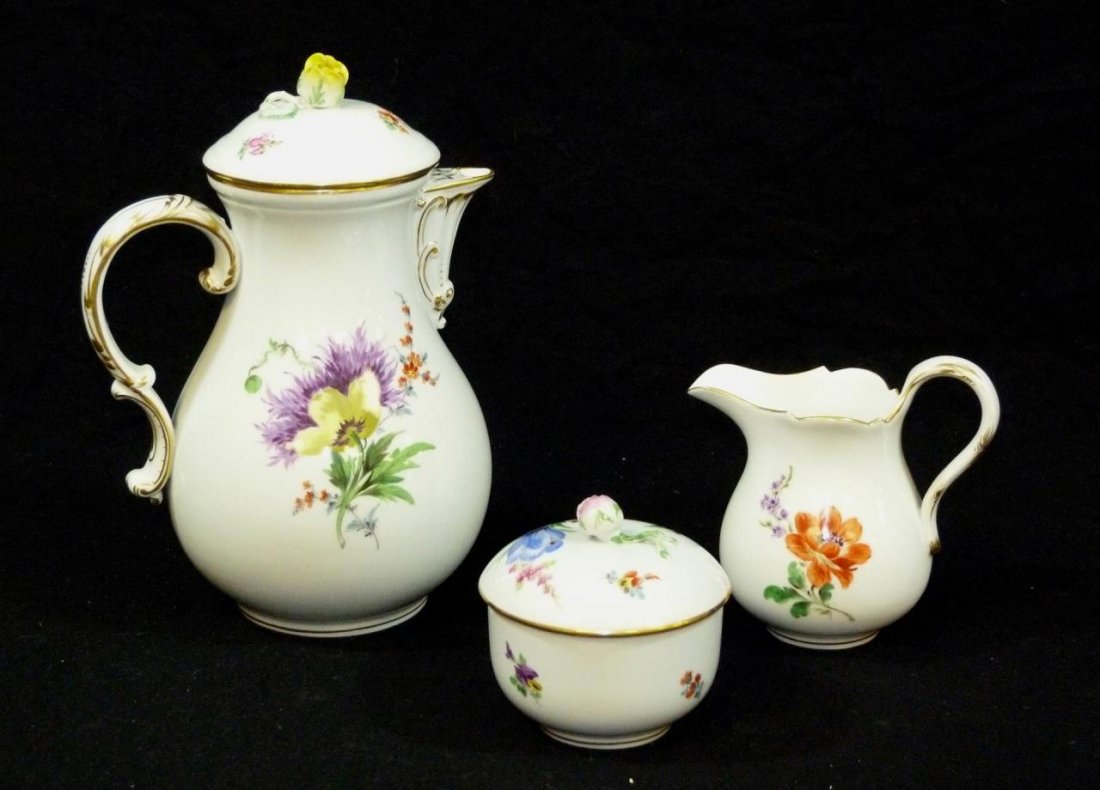 3 PIECE MEISSEN FLORAL PORCELAIN COFFEE SET: Meissen hand painted floral coffee set including a creamer, sugar and covered coffee pot. Each holding blue crossed swords mark with dot to bottom. Circa early 20th century. Tallest measures 9 7/8" he