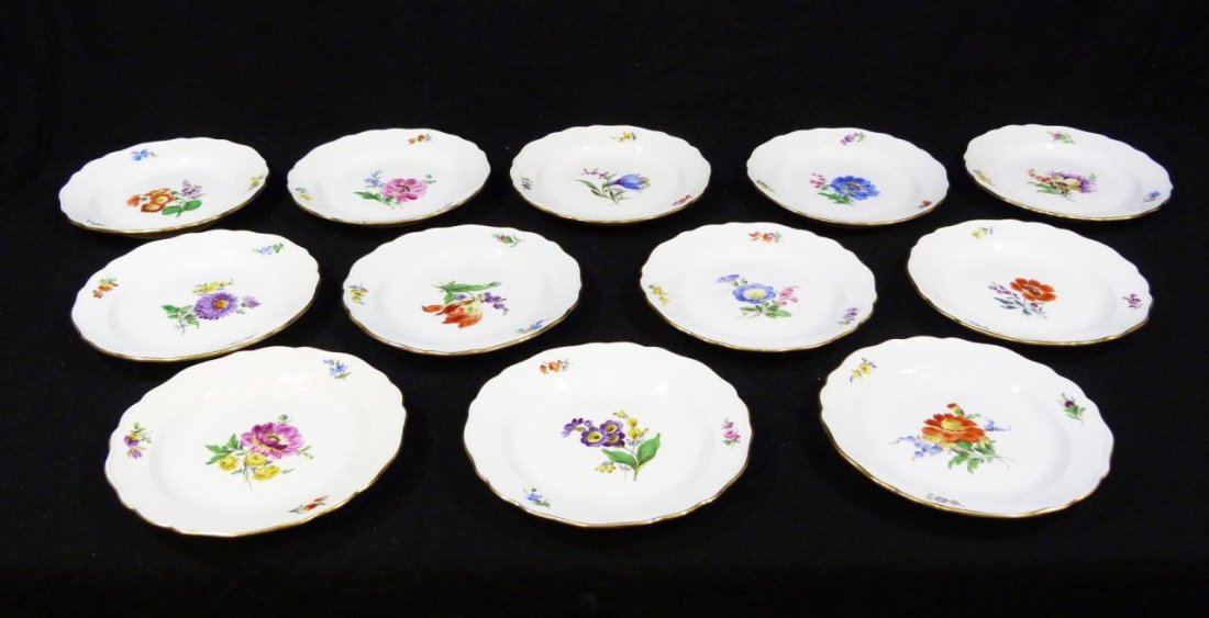 12 MEISSEN PORCELAIN FLORAL BREAD & BUTTER PLATES: A lot of twelve Meissen Germany hand painted porcelain bread and butter plates. Each having a floral design. Bottoms hold blue crossed swords marks. 19th century. Each approx. 6 7/8" diameter (17.4cm)