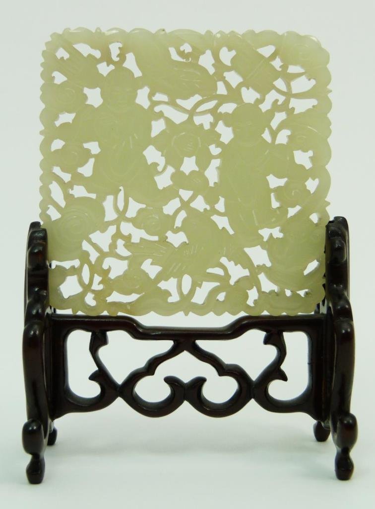 CHINESE OPENWORK CARVED WHITE JADE PLAQUE w STAND: A Chinese hand carved and fully reticulated white jade plaque depicting children with musical instruments, fish and various items. Has fitted wooden stand with lingzhi fungus design. Circa late Qing d