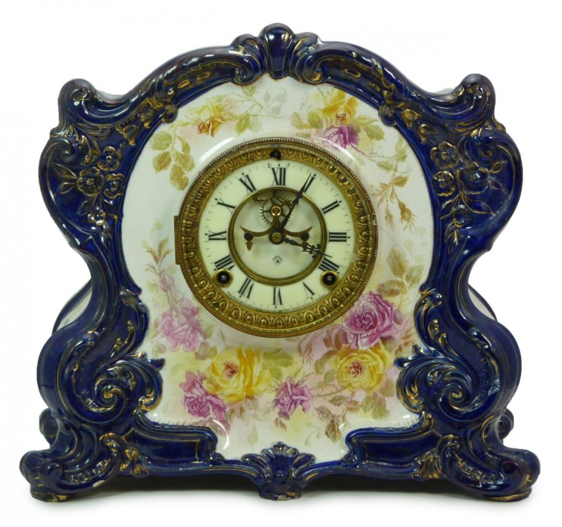 ANSONIA COBALT FLOW BLUE CHINA CASE MANTEL CLOCK: An Ansonia cobalt flow blue porcelain case mantel clock. Hand painted floral design throughout over cobalt blue ground with gold flecking. Royal Bonn Porcelain mark to verso with 'La Cantal'. Patent m