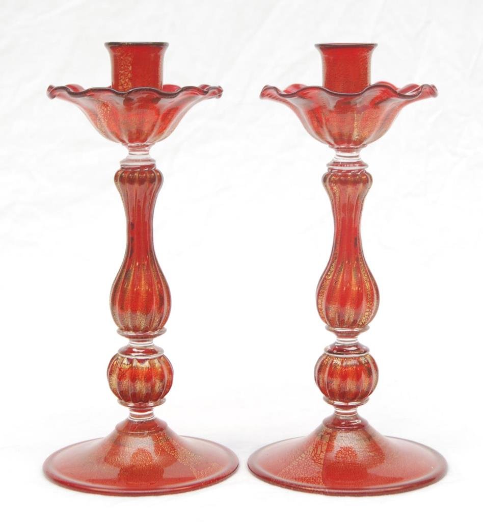 Pr ARCHIMEDE SEGUSO MURANO GLASS CANDLESTICKS: A pair of Archimede Seguso Murano Italian hand blown glass candlesticks having a ruby to clear design with gold flecking throughout. Circa 1950. Measures 9 7/8" height (25cm). Total weight of 761 gram
