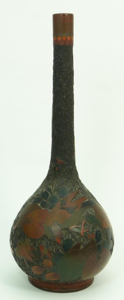 ANTIQUE JAPANESE TREEBARK CLOISONNE VASE: Antique Japanese 'Treebark' cloisonne enameled porcelain bottle form vase. Has a figural tree texture and tone throughout with enameled floral designs. Circa Edo to Meiji period, 18th/19th century. Me