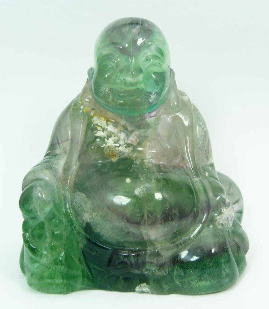 CHINESE CARVED GREEN QUARTZ & AMETHYST BUDDHA: A Chinese carved green quartz and amethyst sculpture depicting a seated Hotei Buddha. Light to deep green tones with white and violet suffusions. Circa 19th/20th century. Measures 3 1/8" height x 3" w