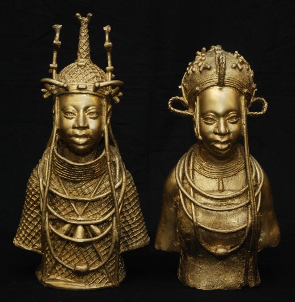 PAIR OF VINTAGE AFRICAN BRONZE KING AND QUEEN: Pair of mid century African queen and king, bronze busts. measures 15 "( 78.6cm) tall each painted in antique gold . no apparent signature, both in original garb. just under 7000 gms