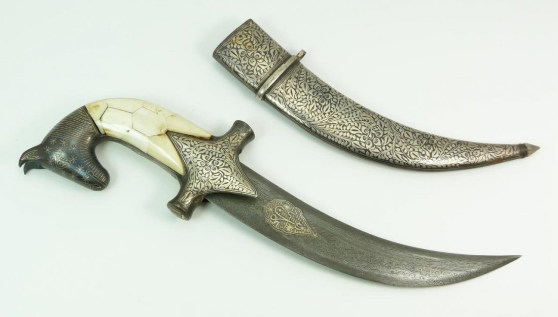 DAMASCUS BONE HANDLE HORSE HEAD MUGHAL DAGGER: A Damascus steel Mughal dagger having a bone design to handle with figural horse head. Includes original fitted sheath. Measures approx. 14 1/4" length (36.1cm). Total weight of 505 grams.