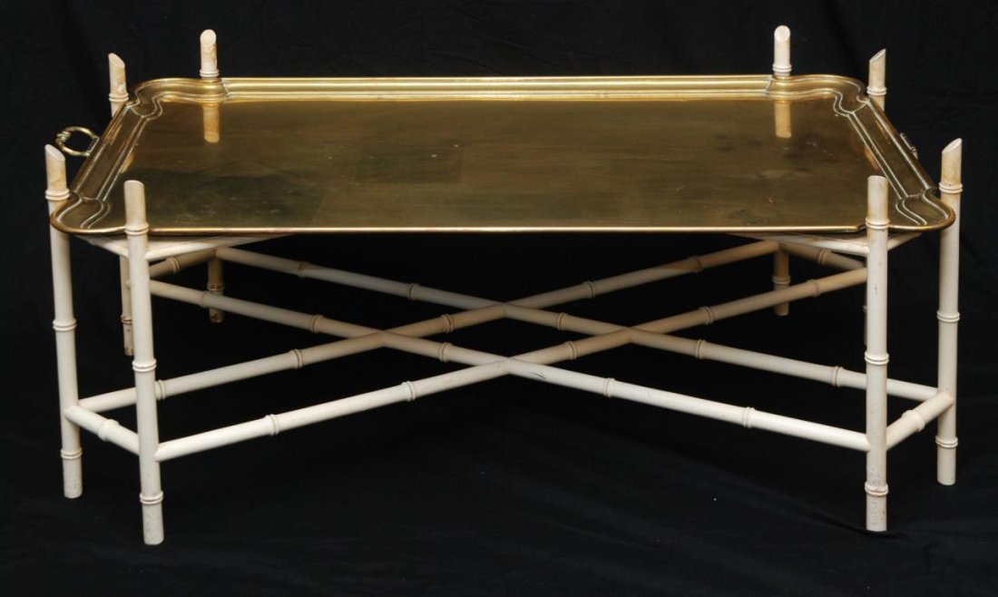 ORIENTAL BRASS & BAMBOO TRAY COFFEE TABLE: Oriental bamboo style coffee table with brass handled tray top. 20th century. Measures approx. 25" height x 55" length x 29" depth (63.5cm x 139.7cm x 73.6cm).