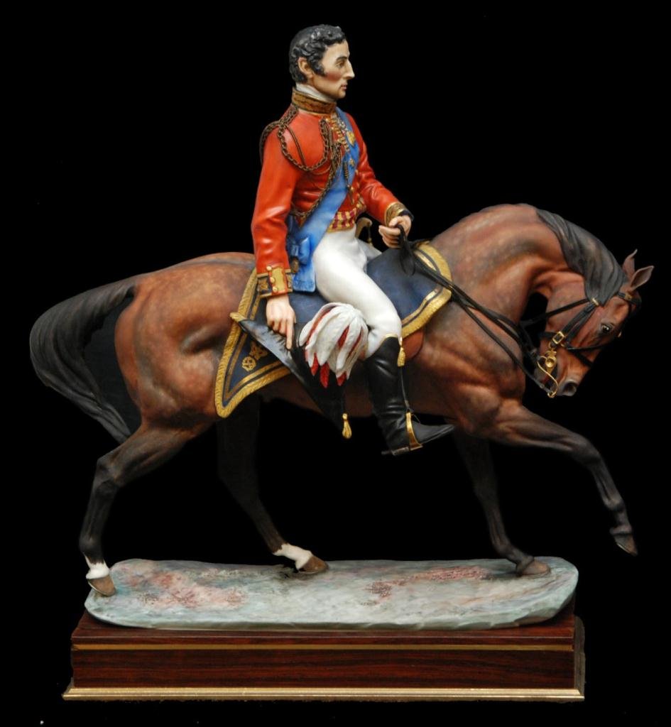 ROYAL WORCESTER 'WELLINGTON' PORCELAIN FIGURE: Royal Worcester English porcelain figure depicting the Duke of Wellington on horseback with hat in right hand. Includes fitted wooden base with name plaque. Dated 1969 on bottom. Modeled by Bernard Wi