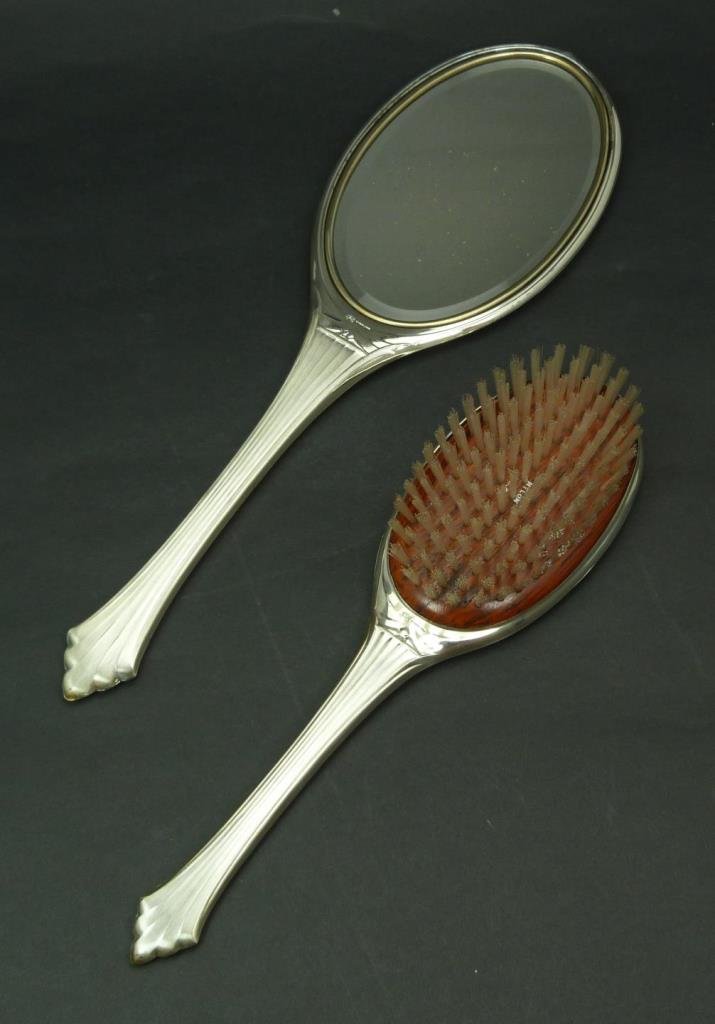 ART DECO STERLING VANITY BRUSH & MIRROR: ART DECO STERLING VANITY BRUSH & MIRROR Consisting of a 13" hand mirror (33.02cm) marked sterling unmonogrammed along with a matching 10" never used brush. With nylon bristles and sterling handle. Tot