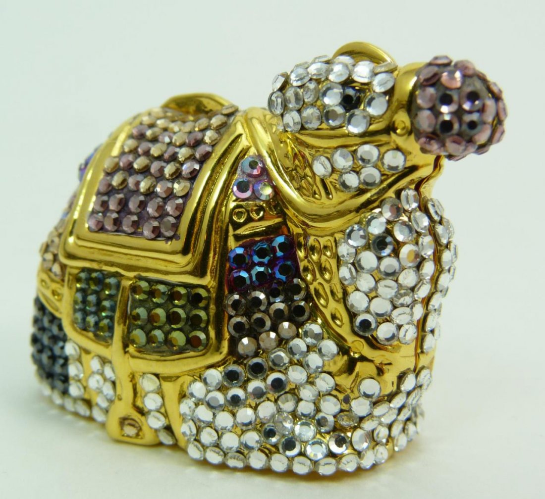 JUDITH LEIBER JEWELED CAMEL TRINKET BOX: JUDITH LEIBER JEWELED CAMEL TRINKET BOX WITH SWAROVSKI CRYSTAL Measures 1-1/2" long (3.81cm) multi colored swarovski crystals over gold tone metals. Comes with original dust bag and box. total weight