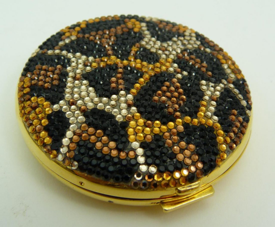 JUDITH LEIBER JEWELED COMPACT: JUDITH LEIBER JEWELED COMPACT Comes with original box. Retail price $385. Measures 2" in diameter (5.08cm) in a snake skin motif done with swarovski crystals. Weighs 96g