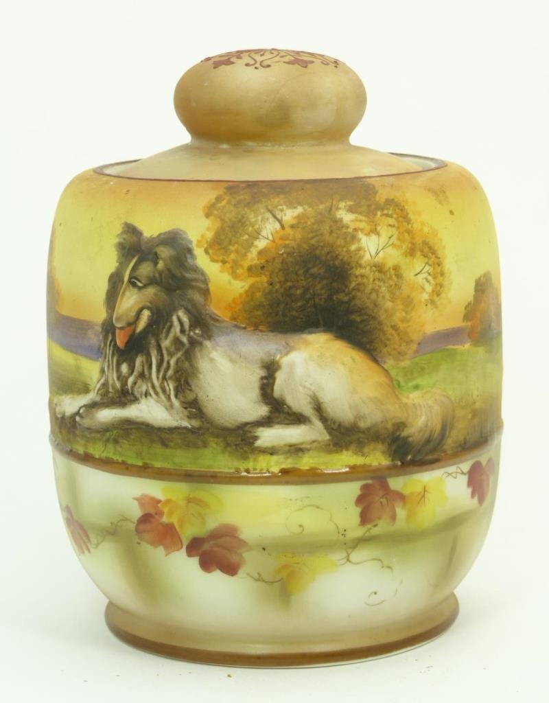ANTIQUE NIPPON BLOWN OUT HUMIDOR WITH COLLIE DOG: Antique Nippon green wreath humidor. Stands 6" (15.24 cm) tall has a blown out image of a collie dog on side sitting in a field. these blown out porcelain pieces are getting harder to find, circa turn
