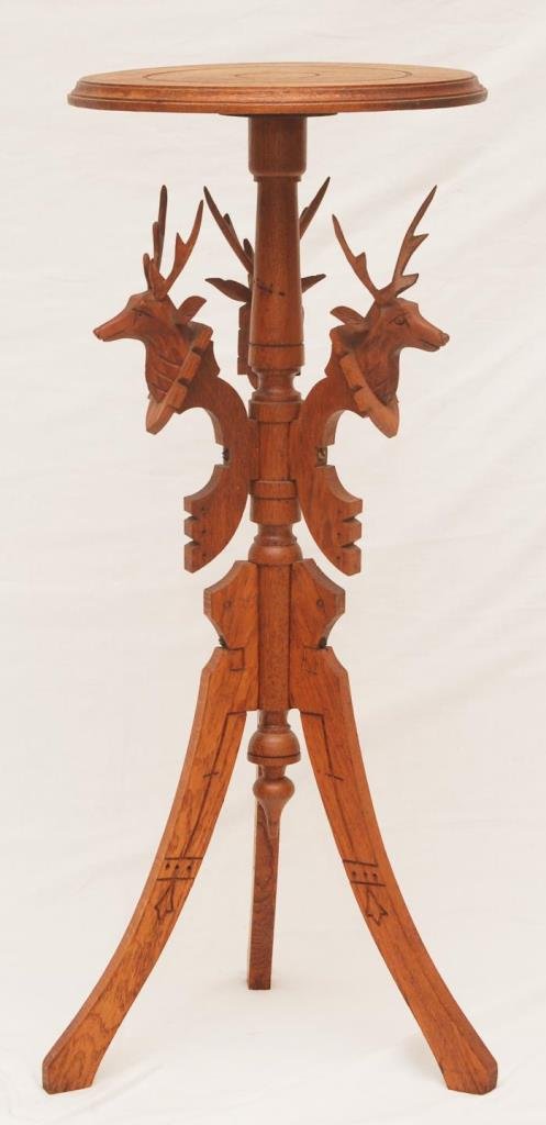 CARVED OAK CANDLE TABLE WITH ELK MOTIF: CARVED OAK CANDLE TABLE WITH ELK MOTIF Elk motif oak table. Measures 32-1/2" tall (82.55cm) with 3 carved elk heads. Table stands on 3 carved wooden legs. Circa 1930's.