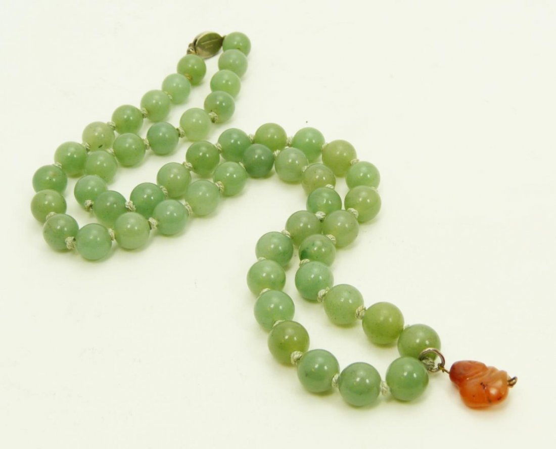 ANTIQUE JADE SILVER & CARNELIAN CHINESE NECKLACE: ANTIQUE CARVED JADE SILVER & CARNELIAN CHINESE NECKLACE Measures 24" long (60.96cm) with 51 6mm jade beads and a small carnelian carved owl pendant. Early 20th century. Total weight of 85g