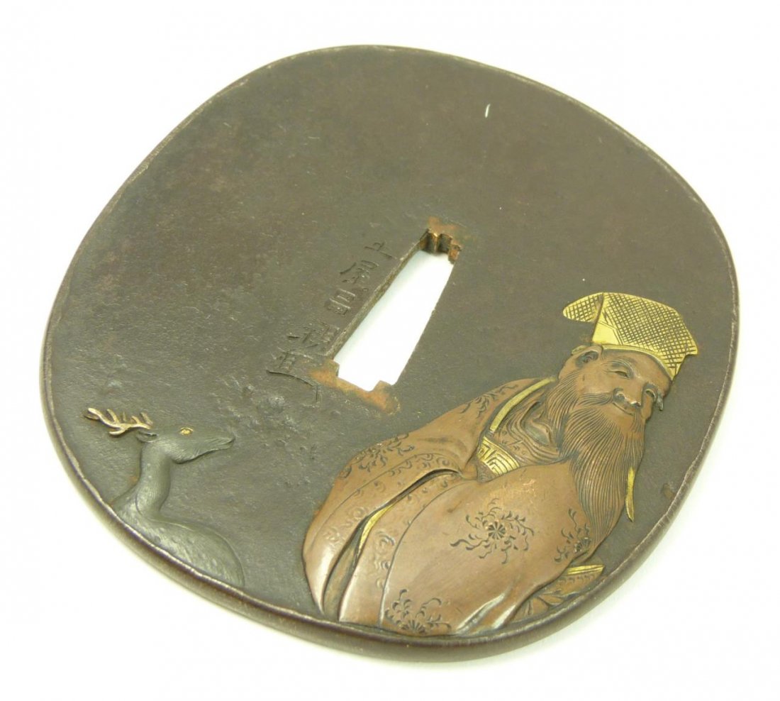 ANTIQUE JAPANESE TSUBA SAMURAI SWORD GUARD: ANTIQUE JAPANESE TSUBA SAMURAI SWORD GUARD Mixed metal, 22kt gold, bronze & copper. Depicting a wise man and deer with egret to base. Measures 3-1/2" long (8.90cm) Total weight 175g.