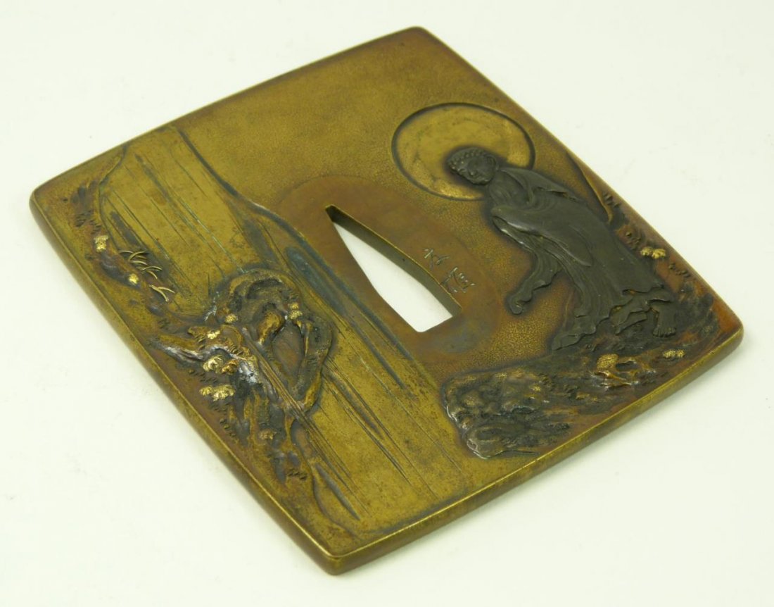 ANTIQUE JAPANESE TSUBA SAMURAI SWORD GUARD: ANTIQUE JAPANESE TSUBA SAMURAI SWORD GUARD Mixed metal, bronze & copper. Depicting a Quan Yin with many faces to back. Measures 3" long (7.62cm) Total weight 174g.