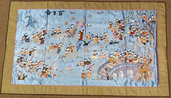 CHINESE HAND WOVEN SILK WALL HANGING: Hand woven silk wall hanging crafted in China. Depicts children playing in a vivid multicolor design. In the scene children, a bridge, trees, toy boats and kites can be seen. Signed upper left. 20th c