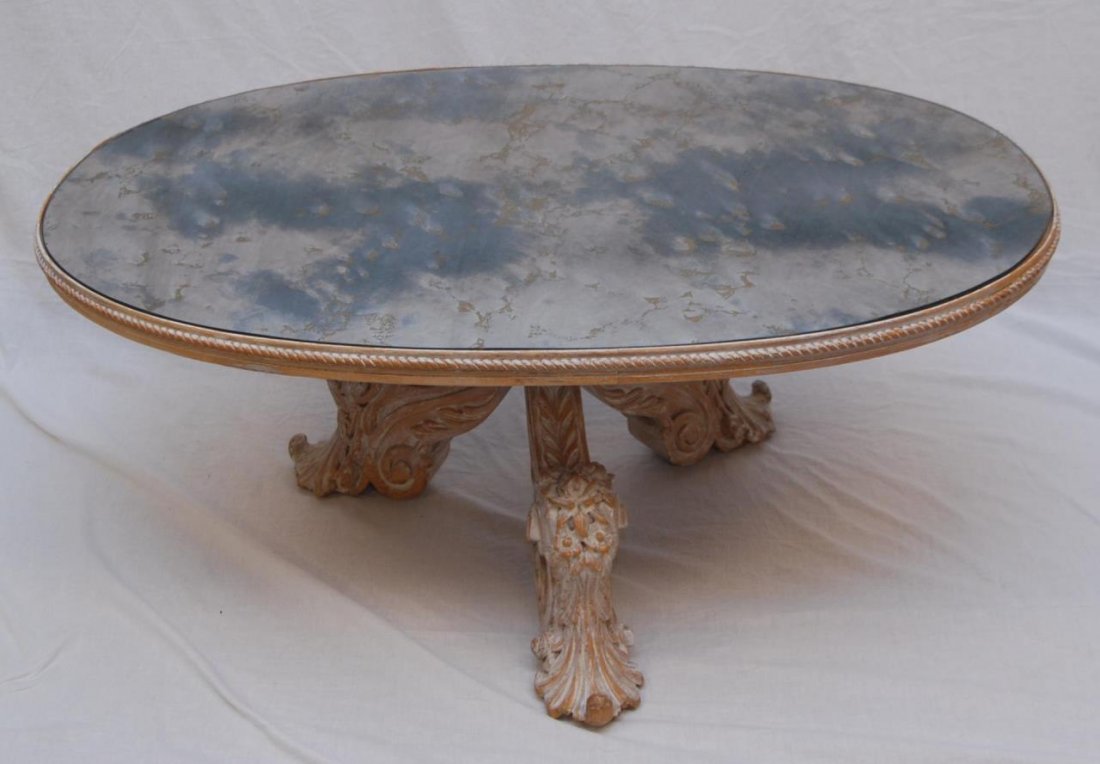 ANTIQUE WHITE WASH OVAL COFFEE TABLE: ANTIQUE WHITE WASH OVAL COFFEE TABLE Smokey mirror insert. Measures 47" long (119.38cm) x 20" tall (50.08cm) Circa 1930's.