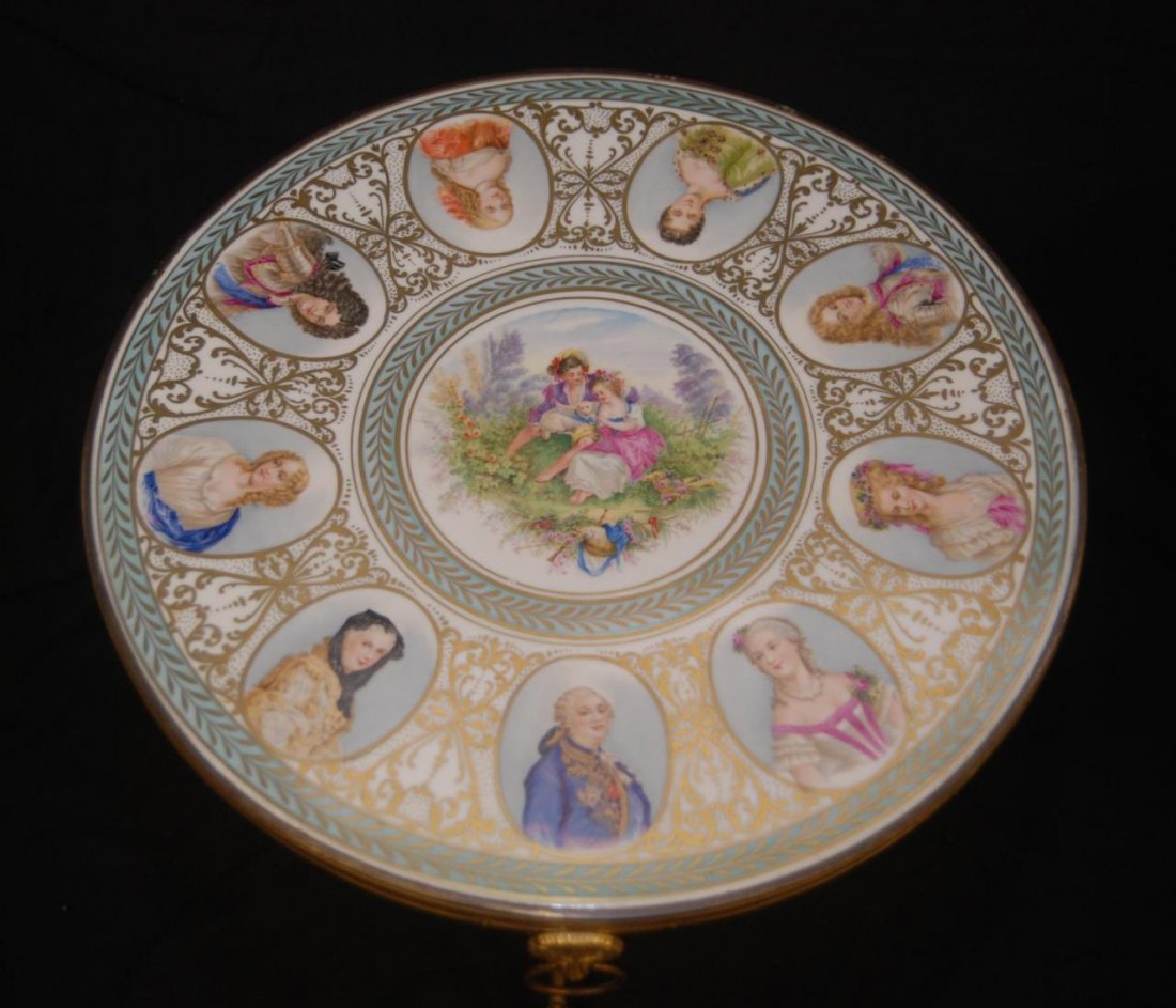 VINTAGE SEVRES STYLE HAND PAINTED PORCELAIN TABLE: LOVELY VINTAGE SEVRES STYLE HAND PAINTED PORCELAIN TABLE Table measures 17-1/2" in diameter (44.45cm) x 22" tall (55.88cm) Has 2 lion handles. Sits on 4 brass feet. It is adorn with portraits. Circa e
