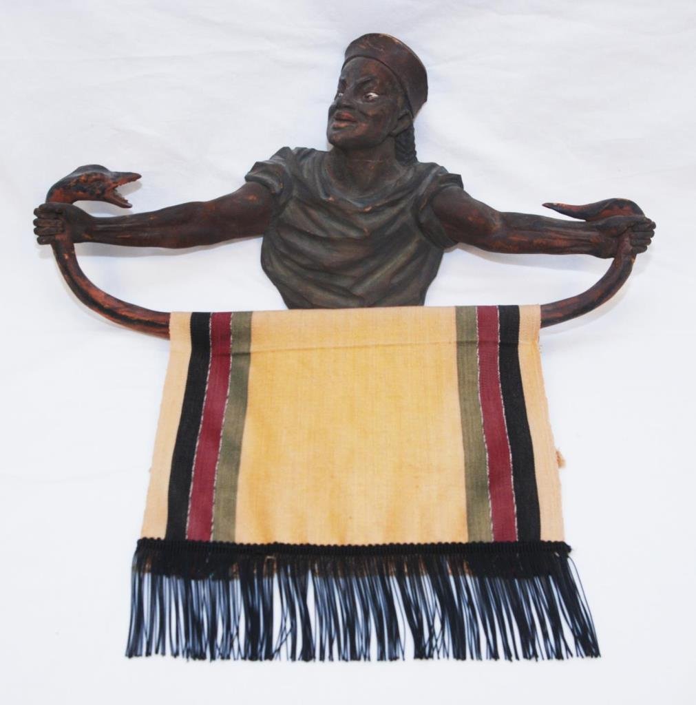 ANTIQUE CARVING OF A BEDOUIN PRAYER RUG HOLDER: ANTIQUE CARVING OF A BEDOUIN PRAYER RUG HOLDER Depicts a Bedouin holding a cobra snake with prayer rug wrapped around. Measures 23" across (58.42cm). Total weight 978g
