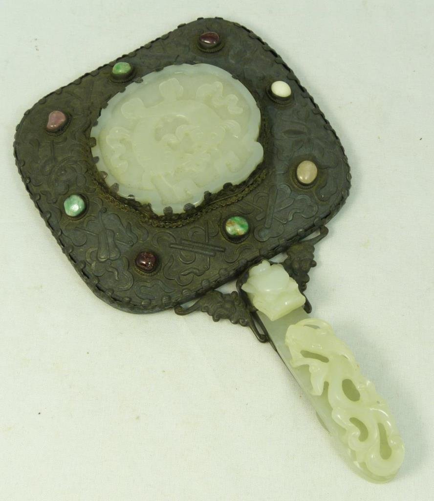 CHINESE DRAGON HANDLE JADE & JEWEL HAND MIRROR: ANTIQUE CHINESE DRAGON HANDLE JADE & JEWEL HAND MIRROR On Chinese silver with jade, quartz and other semi precious gems. Mirror measures 8" long (20.32cm). Jade dragon insert to top, along with handle