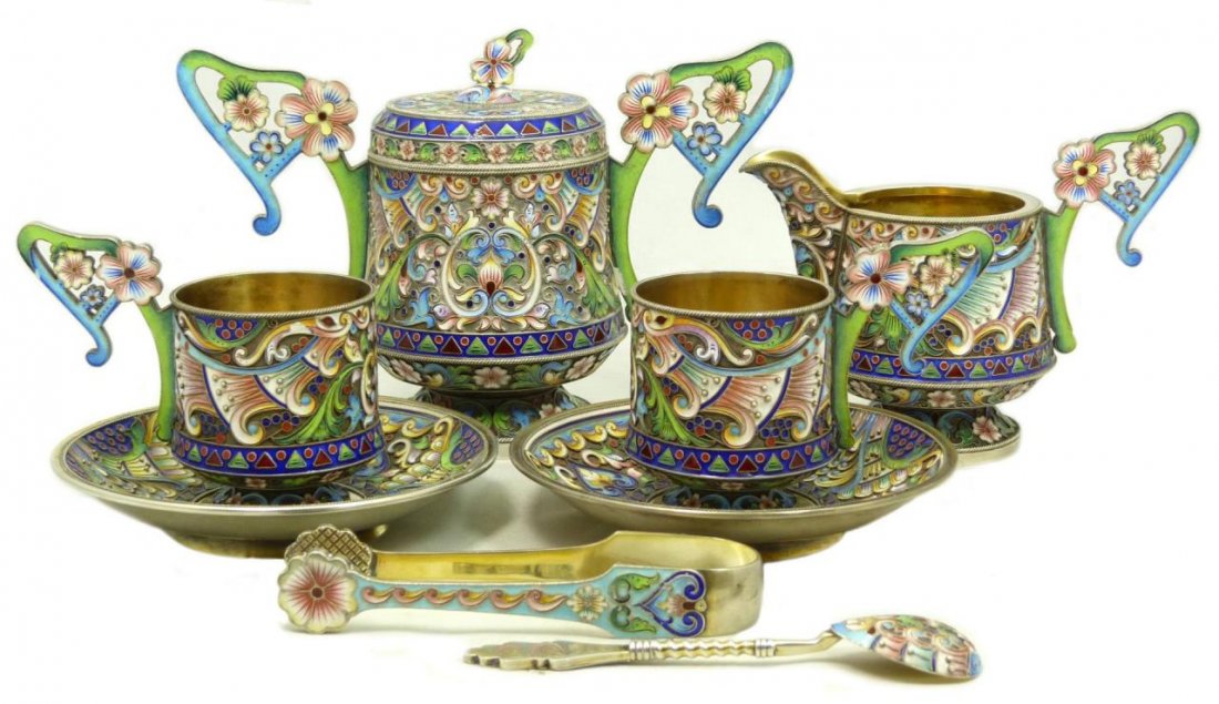 8 PIECE ANTIQUE RUSSIAN ENAMEL TEA SET: 8 PIECE ANTIQUE RUSSIAN ENAMEL TEA SET Each piece bears the mark Maria Semonova Moscow 1908-1917 Consisting of 5" covered sugar (12.7cm), creamer, 2 cups and saucers, tongs and spoon. Decorated was be