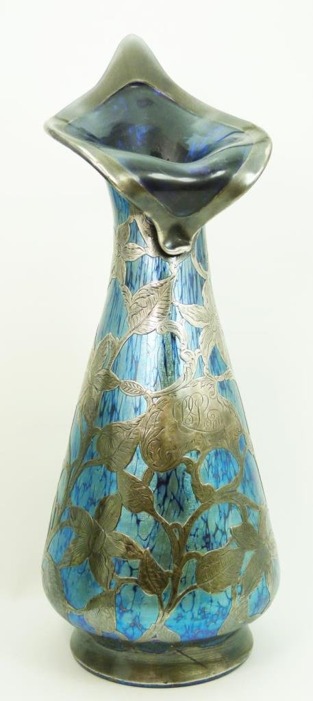 HUGE LOETZ SILVER OVERLAY JACK IN THE PULPIT VASE: HUGE LOETZ SILVER OVERLAY JACK IN THE PULPIT VASE Iridescent blue with silver floral overlay throughout entire vase. Top forms a jack and pulpit shape. Polish pontil to base. Measures an outstanding 1